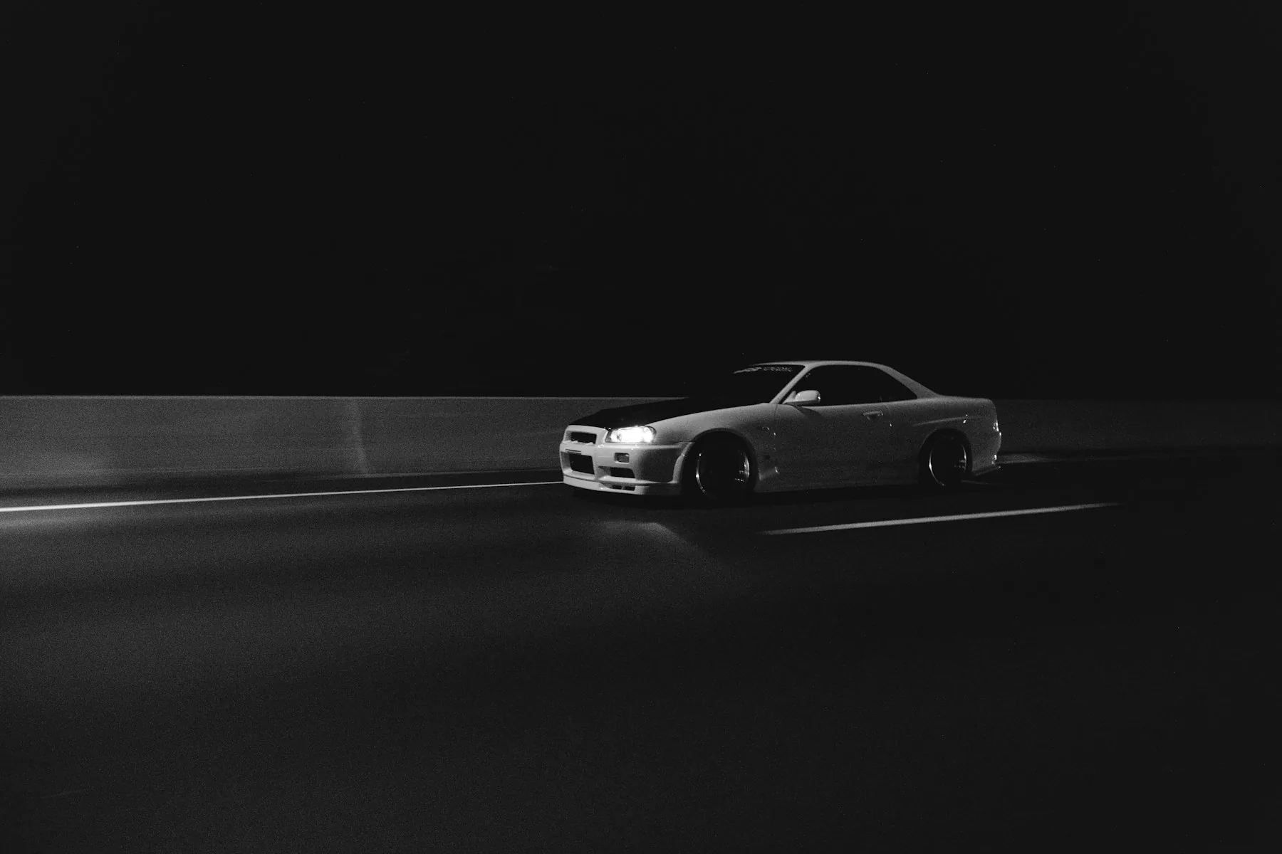 Dark performance car traveling at night